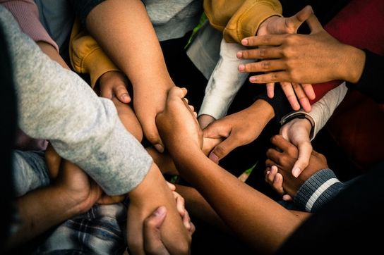 Photo Credit: Marlis Trio. A collage of a many different colored handshakes.