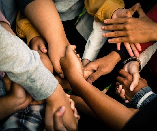 Photo Credit: Marlis Trio. A collage of a many different colored handshakes.