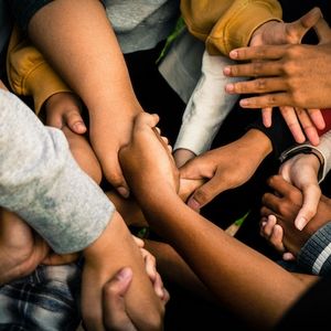 Photo Credit: Marlis Trio. A collage of a many different colored handshakes.